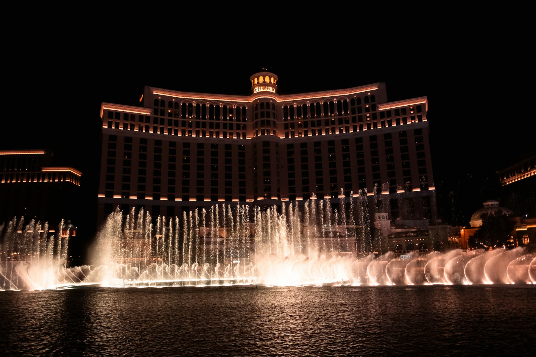 Bellagio fountains and illuminated hotel at night