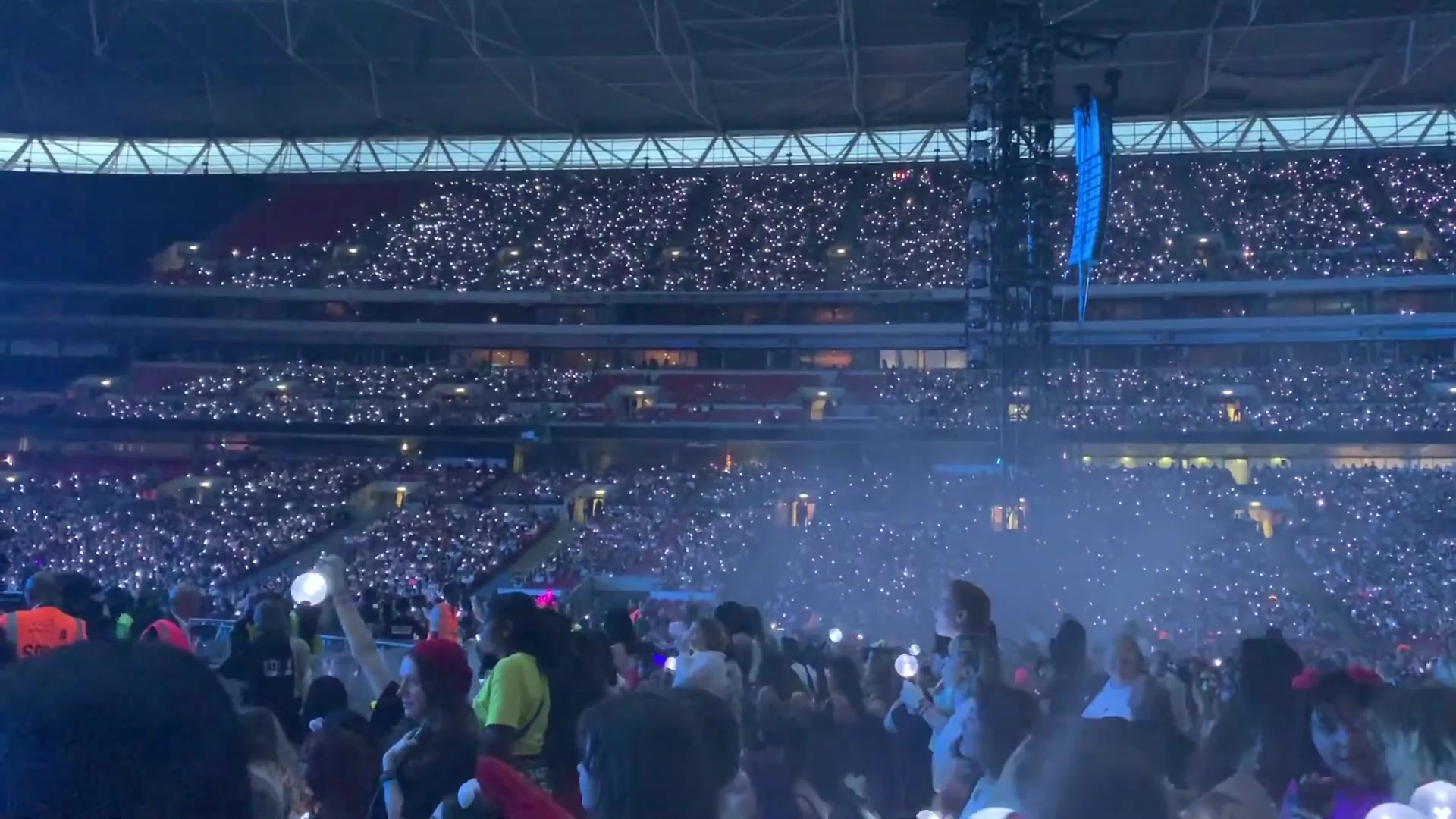 Fans holding illuminated light sticks at the 2019 BTS Wembley concert